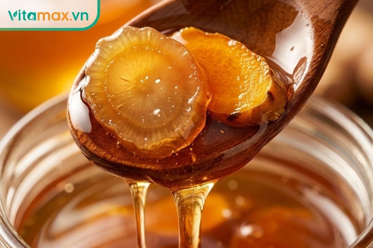 Cận cảnh thìa múc hỗn hợp sâm nghệ mật ong, chất lỏng sánh quyện, miếng sâm trong veo.