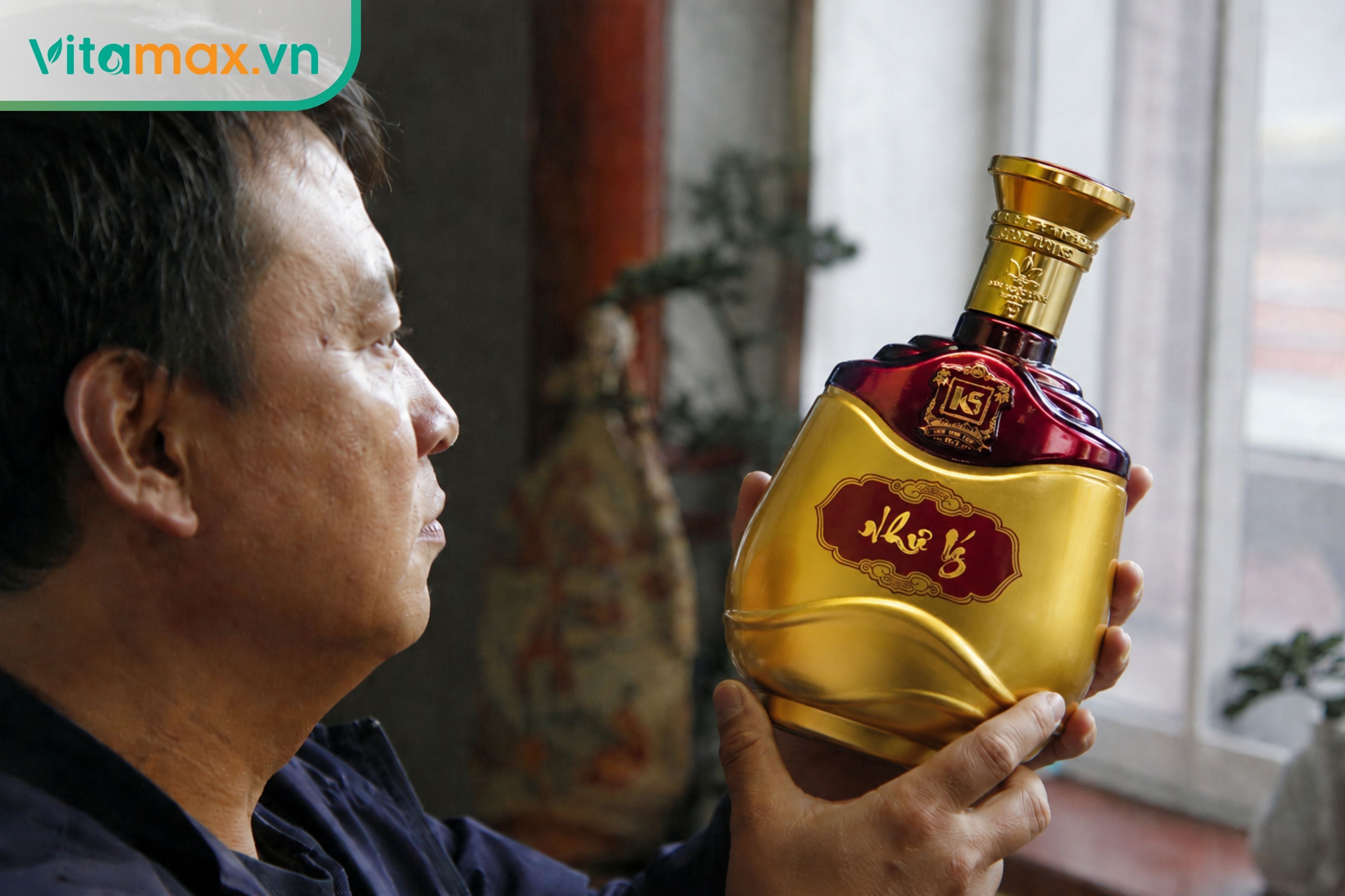 Ảnh thực tế người tiêu dùng đang cầm và quan sát kỹ lưỡng một chai rượu sâm Ngọc Linh thương hiệu K5 đóng chai sẵn để kiểm tra tem mác và hình thức, giúp tránh hàng giả.