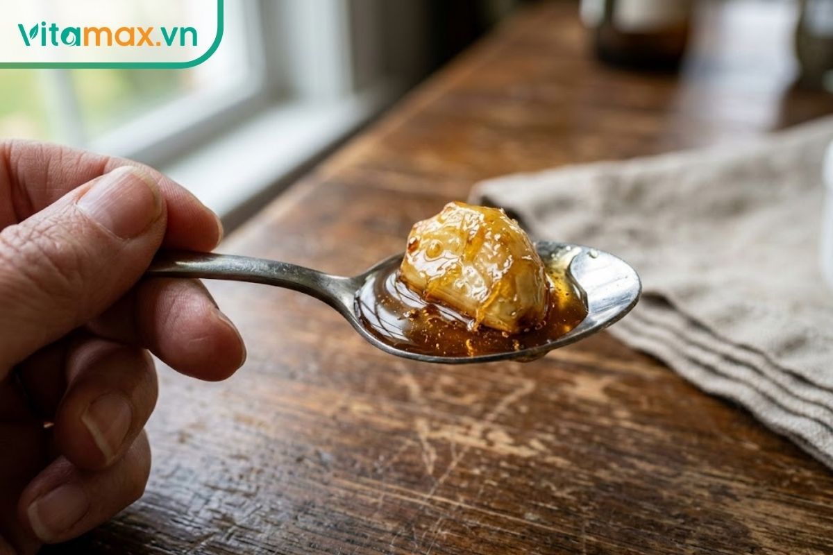Đo lường chính xác liều lượng 1 thìa cà phê khi pha tỏi ngâm mật ong để uống buổi tối.